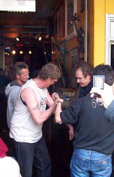 Ray signing Gerard's arm